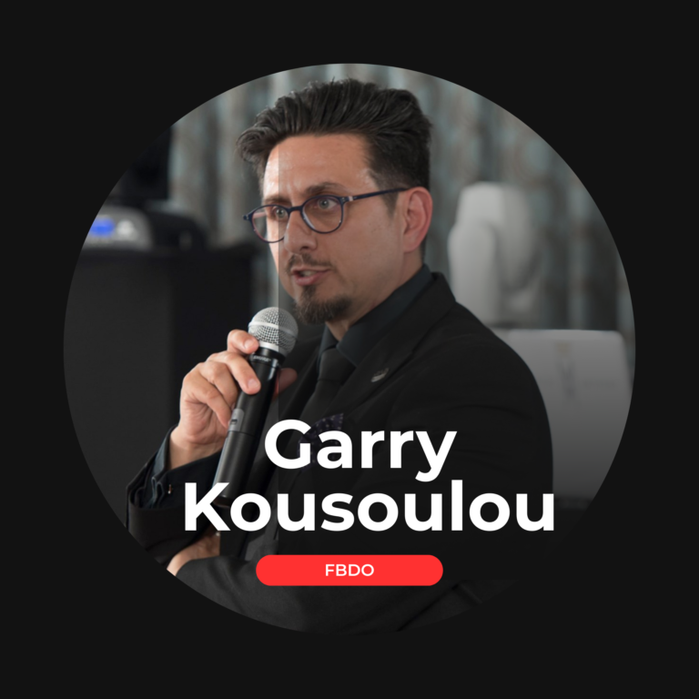 Garry Kousoulou speaking on stage